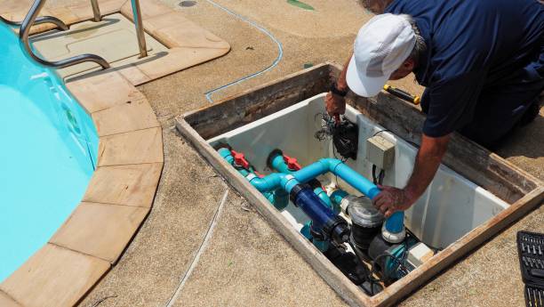 A man working on the engine room of a swimming pool